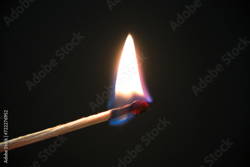 burning match on a black background