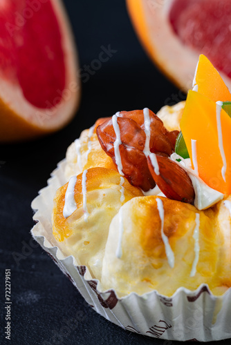 A fruit cake with two pieces of grapefruit on the background