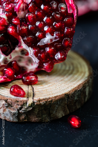 Fresh red pomegranate on the log