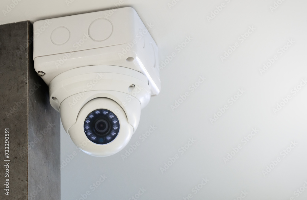 Modern public CCTV camera on the ceiling near the window. Recording camera for monitoring all day and night. Concept of surveillance and monitoring with copy space. Modern public CCTV camera on the ceiling near the window. Recording camera for monitoring all day and night. Concept of surveillance and monitoring with copy space.