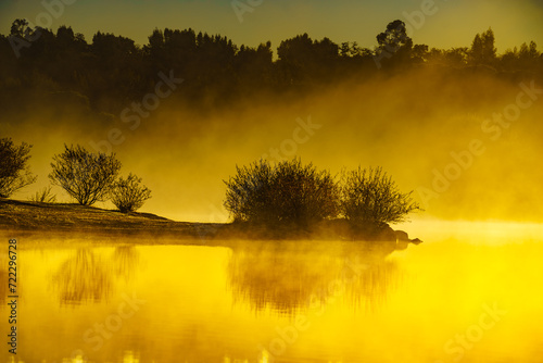Morning fog over autumn lake water photo