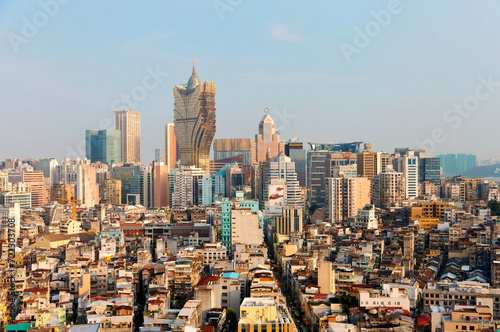 Beautiful urban skyline of vibrant Macao City on a sunny summer day, with the famous landmark luxury Grand Lisboa Hotel & Casino standing among modern buildings under blue clear sky, in Macau, China 