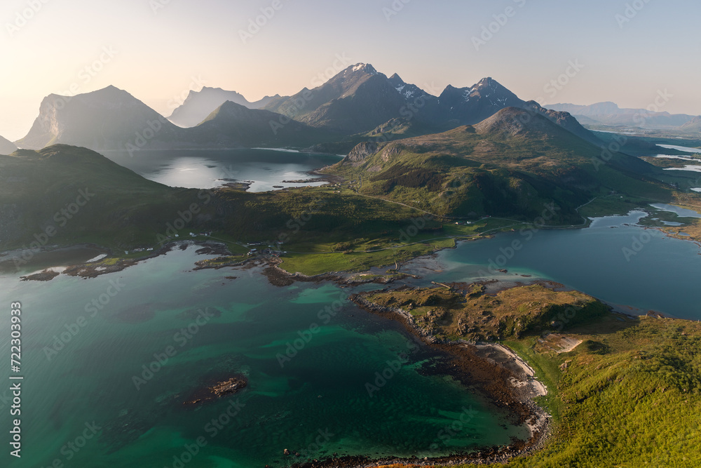 The Offersoykammen peak in Vestvagoya offers stunning views of the Nappstraumen's vibrant waters and Flakstadoya's mountain wall, a favorite local hiking destination. Lofoten, Norway