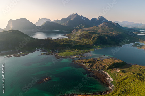 The Offersoykammen peak in Vestvagoya offers stunning views of the Nappstraumen's vibrant waters and Flakstadoya's mountain wall, a favorite local hiking destination. Lofoten, Norway photo