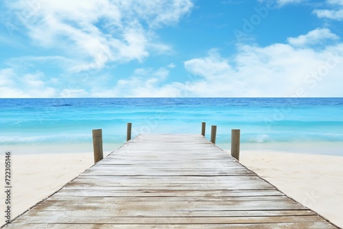 Wooden pier on tropical beach with blue sea and sky background © Urban