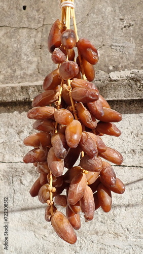 Dates or dattes palm fruit in wooden plate is snack healthy, Set of various dates bowl, Different kind of raw date fruit ready to eat, concrete background, Traditional, delicious and healthy ramadan photo