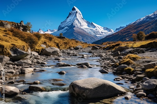 Serenely beautiful alpine mountain landscape with vibrant blue sky and reflective waters