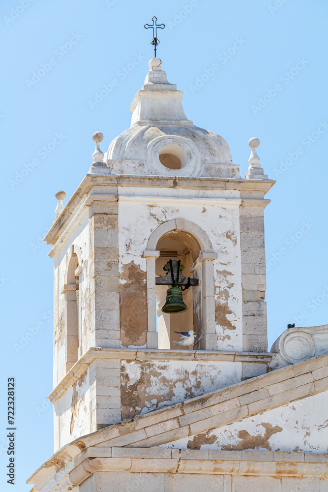 Tower and bell of the Parish Church of Santa Maria de Lagos. Algarve, Portugal.