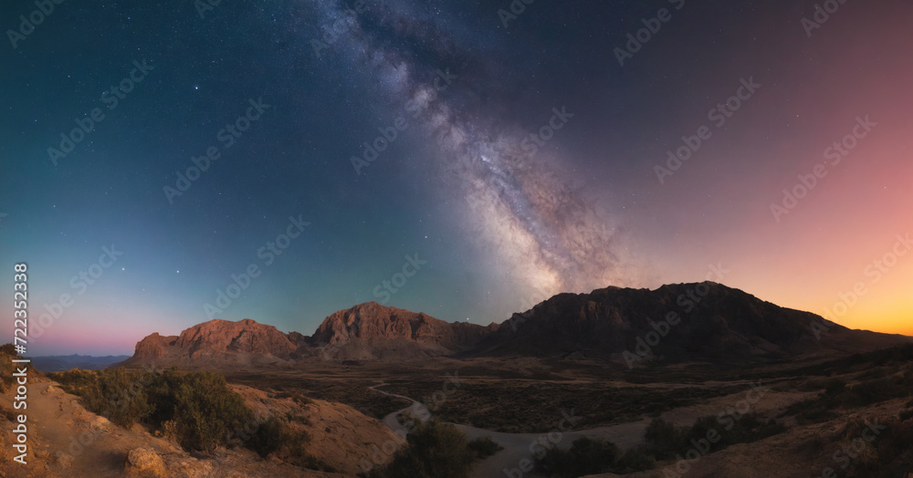 A stunning cosmic landscape featuring a starry purple sky with the Milky Way arching over rocky mountains at sunset.