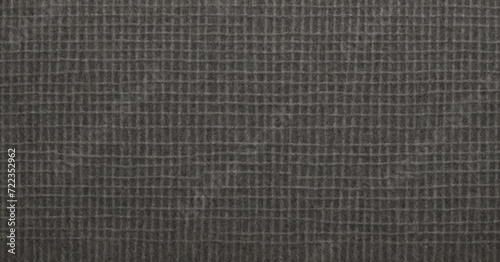 A detailed macro shot of grey felt fabric, displaying its soft and fuzzy texture, perfect for fashion or background designs.