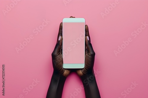 woman hands in pink outfit holding cell phone screen, photo