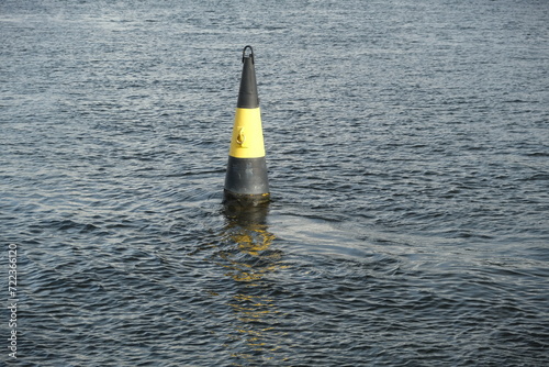 yellow and black buoy on the water