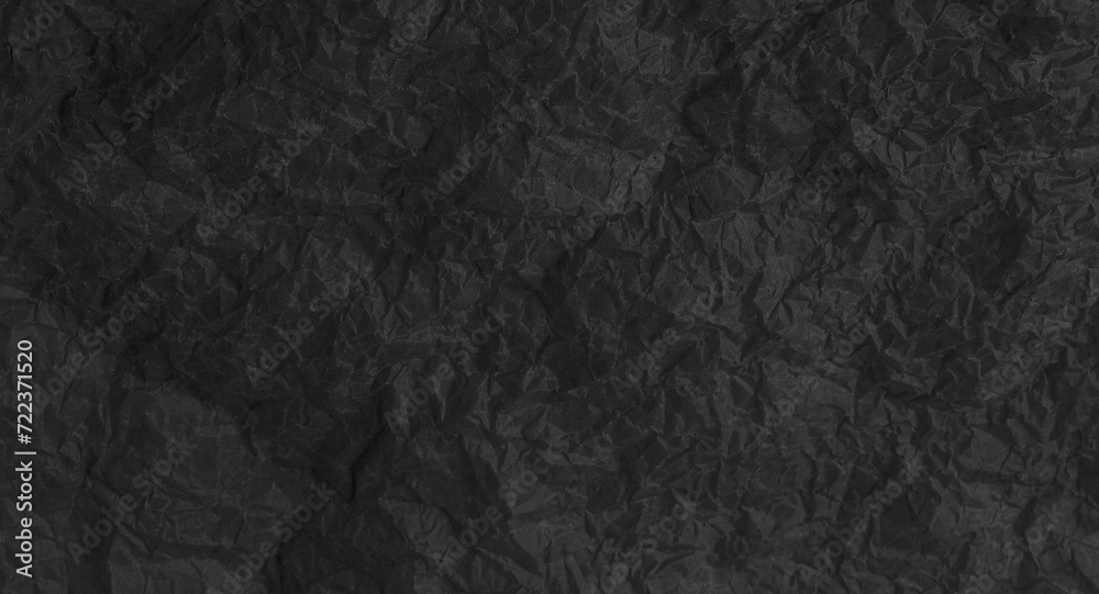 Torn crumpled black paper background Torn crumpled black paper background