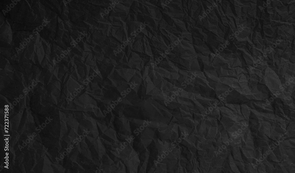 Torn crumpled black paper background Torn crumpled black paper background