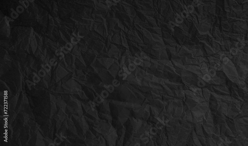 Torn crumpled black paper background