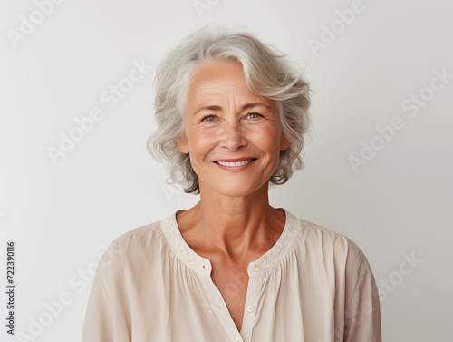 Portrait of happy senior woman on white background