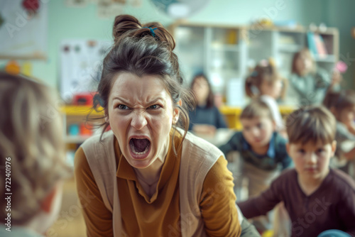 An angry, dissatisfied teacher yells at children in a kindergarten or school. Naughty children photo