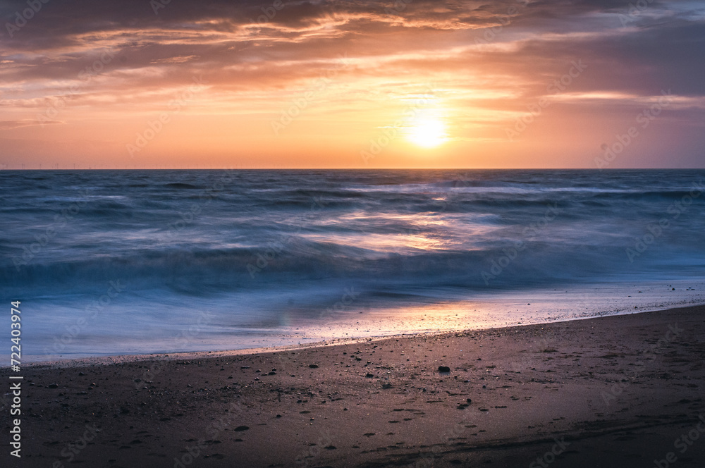 Long exposure shot of the Brighton beach on windy and cloudy day in winter on sunset, East Sussex, UK Long exposure shot of the Brighton beach on windy and cloudy day in winter on sunset, East Sussex, UK