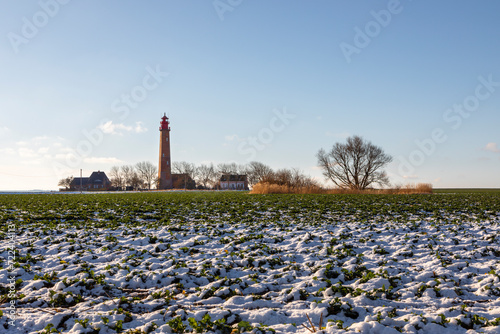Tableau sur toile Der Leuchtturm Flügge auf der Insel Fehmarn im Winter