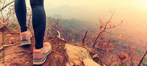 Active woman s legs with sports shoes and backpack running on scenic mountain trail photo