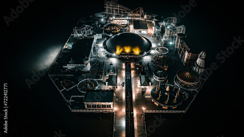 Aerial view of a seaside, Brighton Pier and beach in night lights, Brighton, East Sussex, UK photo
