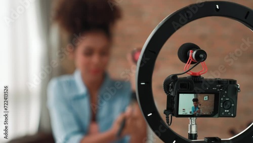 Rear view camera screen recording woman influencer shoot live streaming vlog video review makeup crucial social media or blog. Girl with cosmetic studio lighting for marketing broadcasting online. photo