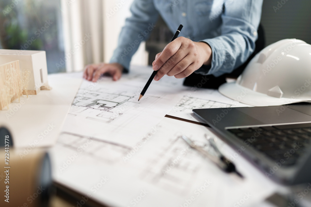 Interior architect or engineer working on blueprint at home office. Interior architect or engineer working on blueprint at home office.