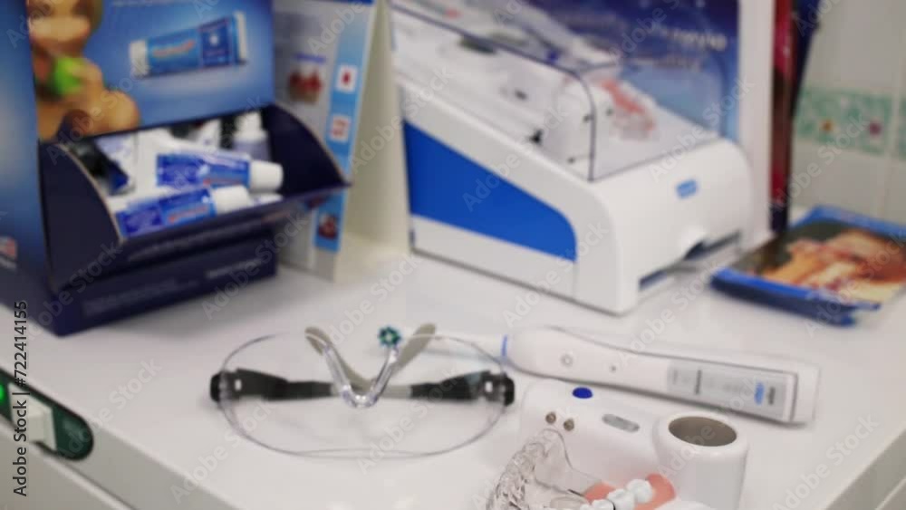 Modern model of jaw, glasses and electrical toothbrush are laying Modern model of jaw, glasses and electrical toothbrush are laying