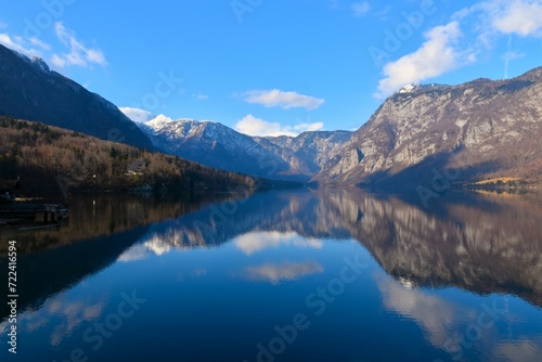 View of lake Bohinj and a reflection of the mountains in Julian alps in the water in Slovenia