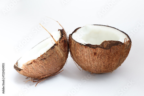Ripe coconuts and half coconut on white background