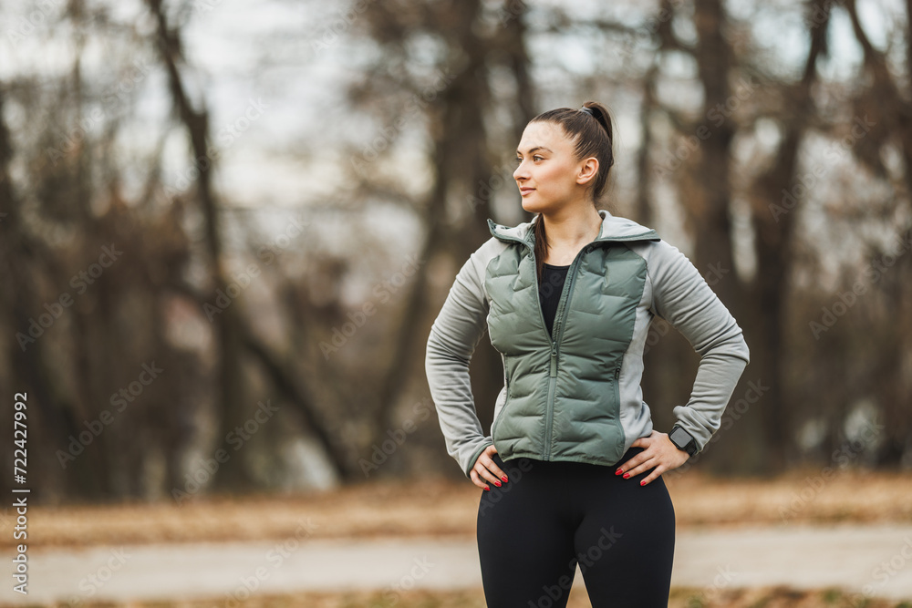 Woman Taking a Break During Outdoor Autumn Jog in Park Woman Taking a Break During Outdoor Autumn Jog in Park