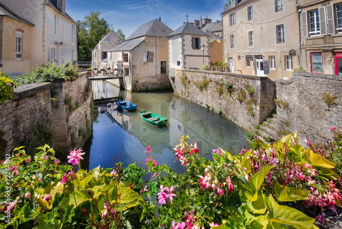 Old Buildings along the quiet Aure River in the medieval old town of Bayeux, France 
