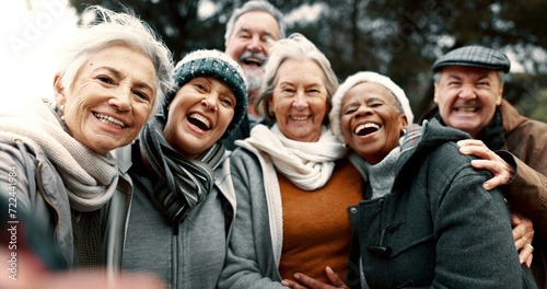 Happy, selfie and senior friends in a park while walking outdoor for fresh air together. Diversity, smile and group of elderly people in retirement taking picture and bonding in a forest in winter.
