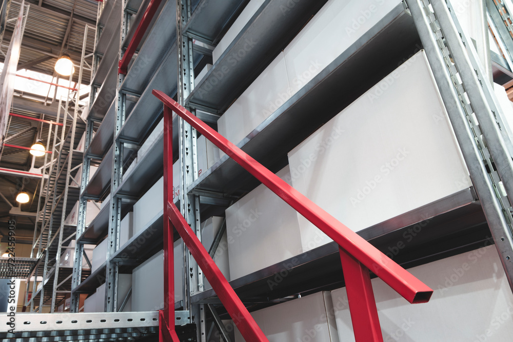 Naklejka premium modern distribution warehouse with boxes on racks