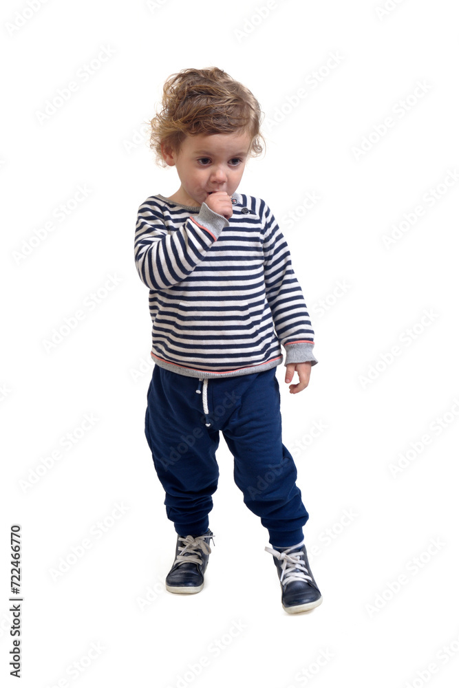 viw of a baby boy standing and thumb yur sucking on white background viw of a baby boy standing and thumb yur sucking on white background