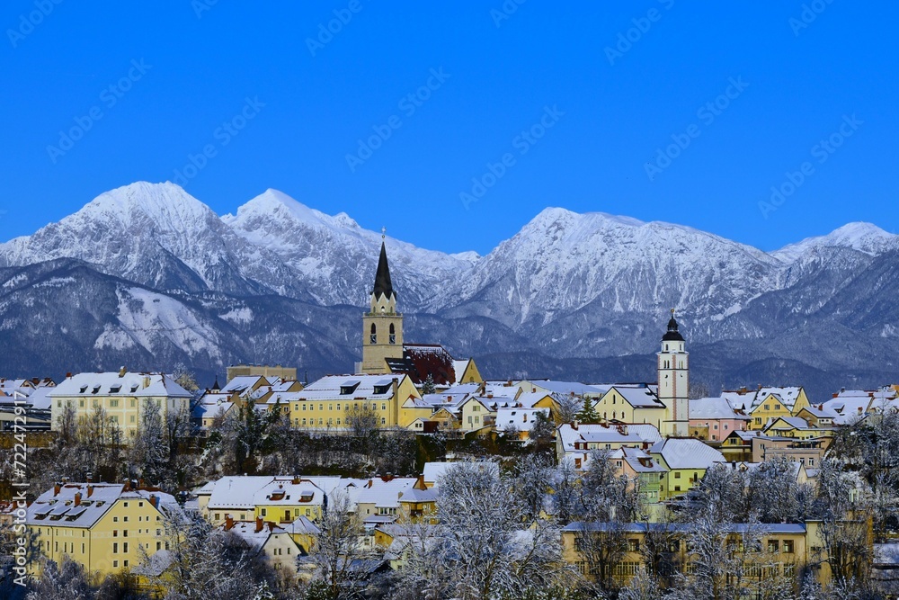 View of old town Kranj and snow covered mountain peak of Grintovec and Skuta in Gorenjska, Slovenia