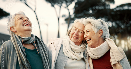 Comedy, laughing and senior woman friends outdoor in a park together for bonding during retirement. Portrait, smile and funny with a happy group of elderly people bonding in a garden for humor or fun photo