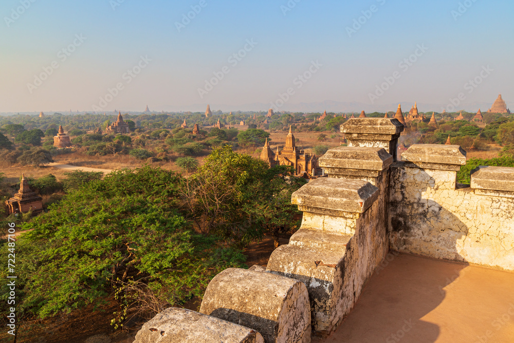 Scenic landscape of many ancient temples and small pagodas at the plain of Bagan in Myanmar (Burma) on a sunny day. Viewed from a balcony of a bigger temple.