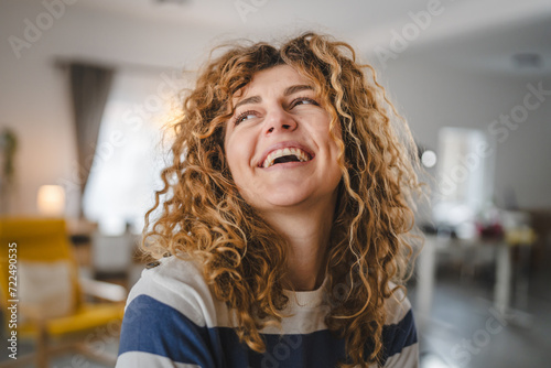 Portrait of adult caucasian woman with curly hair at home happy smile photo