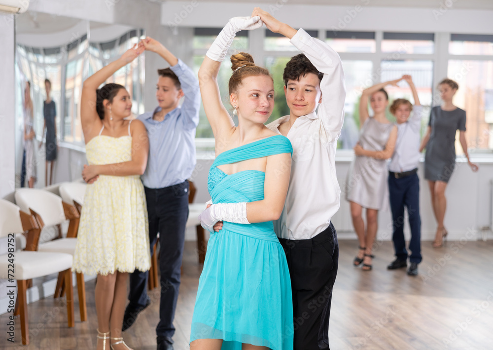 Fototapeta premium Boy and girl dance couples ballroom dance waltz in studio