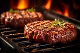 Juicy grilled steaks on a flaming grill with seasoning