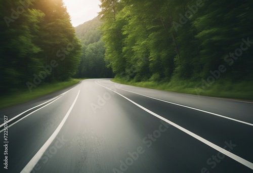 Empty asphalt road and speed motion blur on highway in summer with green trees forest at countryside