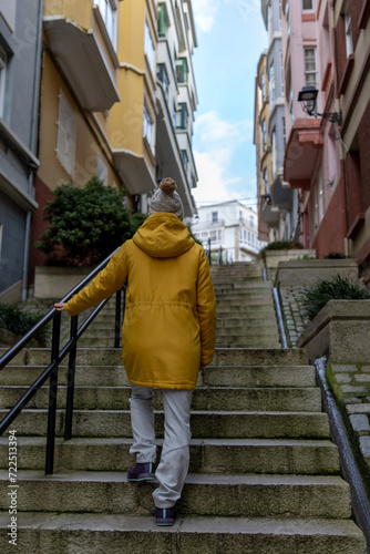 A Vivid Solitary Trek: The Contrast of a Yellow Silhouette Against the Urban Canvas © Pablo Santos Somos