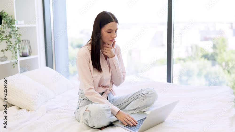 Relaxed lady sitting on comfy bed and enjoying online chatting with coworkers on weekend. Attractive young woman working remotely from home, typing on modern wireless laptop. Relaxed lady sitting on comfy bed and enjoying online chatting with coworkers on weekend. Attractive young woman working remotely from home, typing on modern wireless laptop.