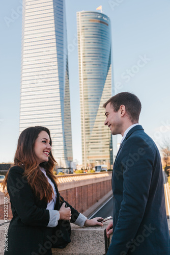 Business colleagues chatting in Madrid with skyscrapers