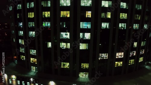 Facade of business center with illuminated windows at evening.  photo