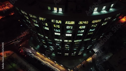 Office edifice exterior with illuminated windows at evening. Aerial view photo