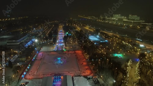 Crowd of people get fun on skating rink and territory of Gorky Park photo