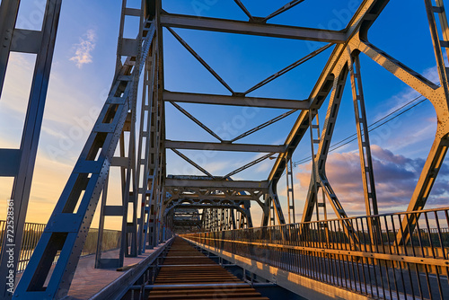 Railway bridge from the inside during repair work at sunset © korsarid