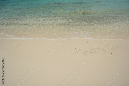 Beautiful blue Caribbean sea water with white foam edge. Space for text. 